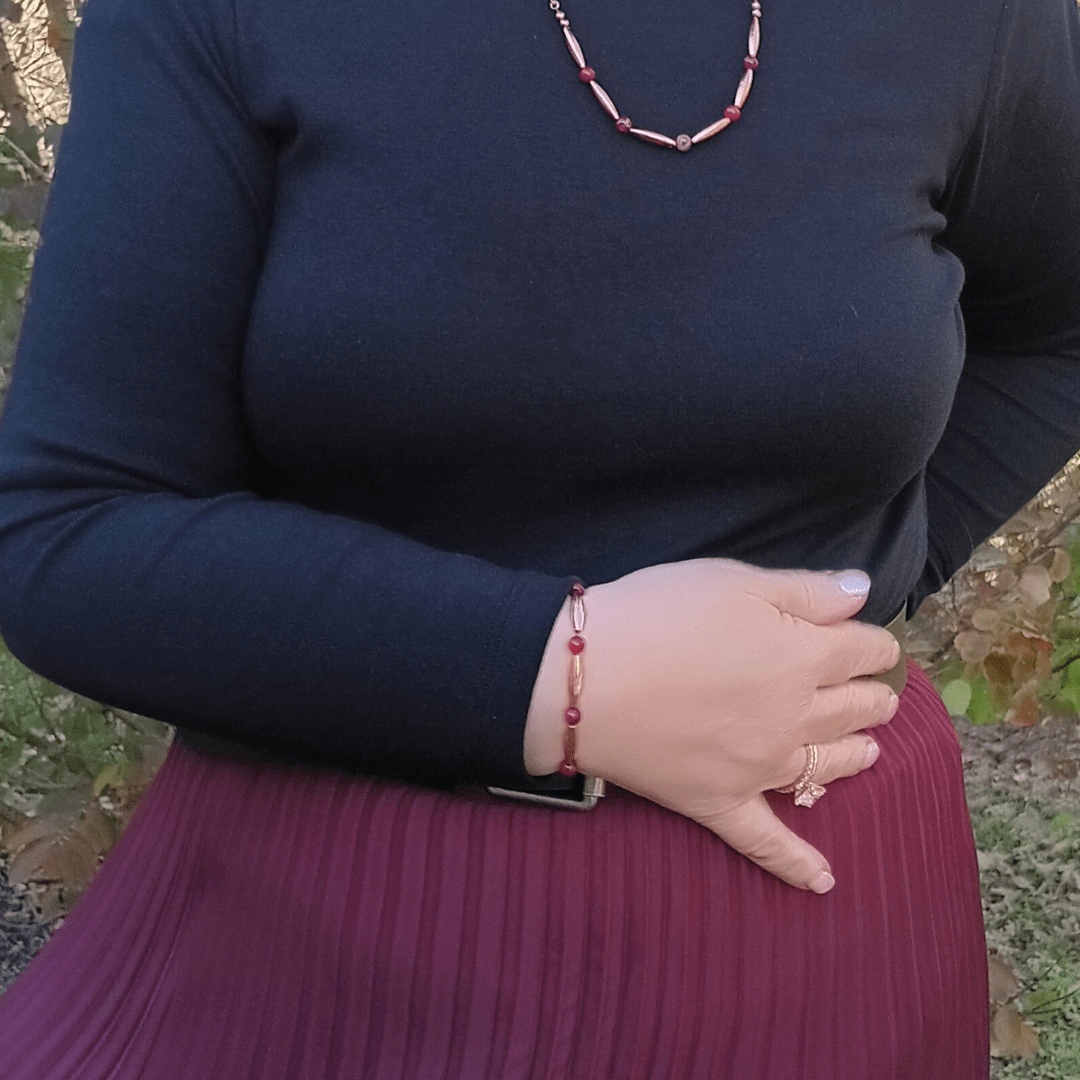 Woman wearing red jewelry and black top