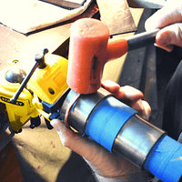 Making copper cuff with a hammer.