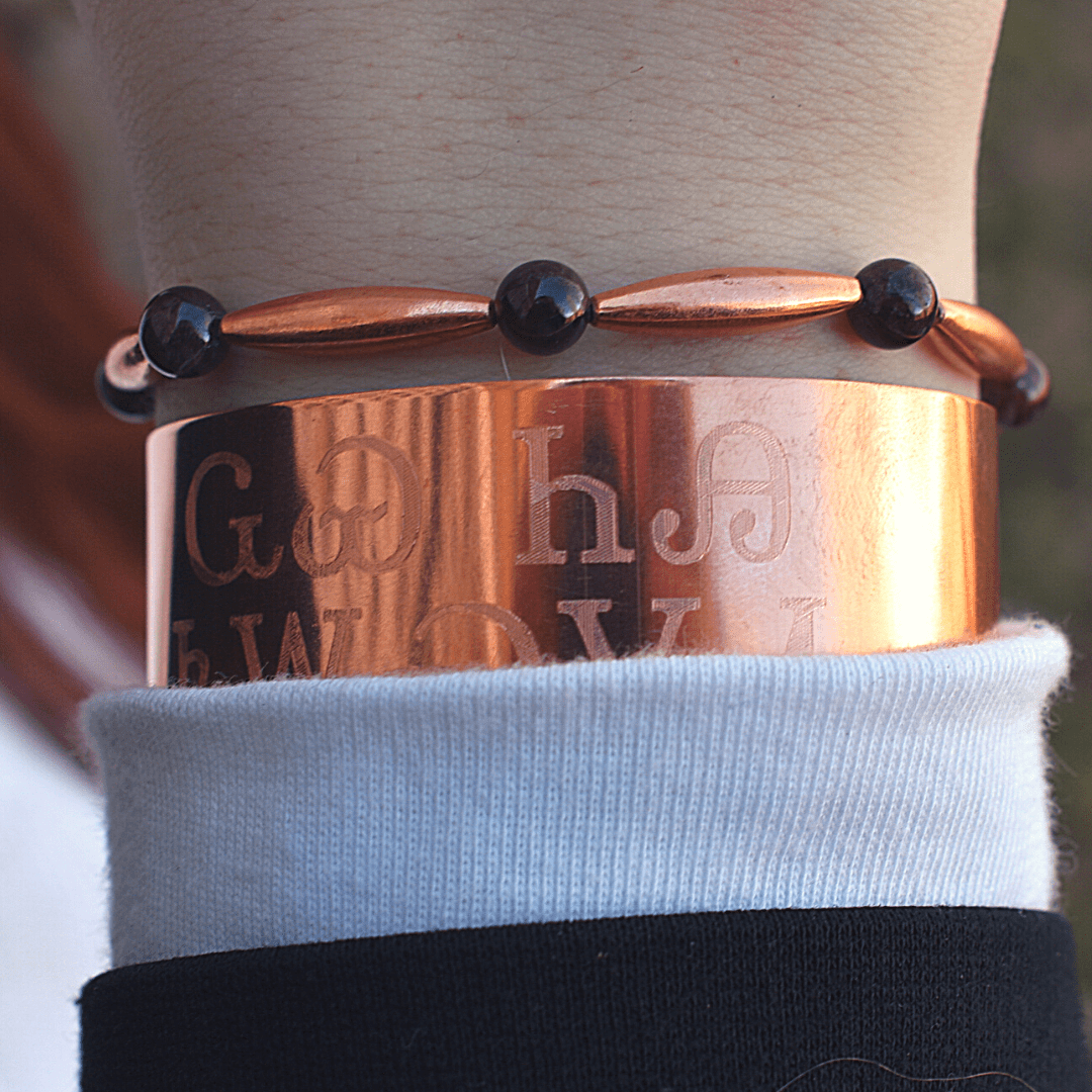 Copper bracelets with engraved text and garnet beads