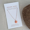 Copper necklace with turtle pendant on white card.