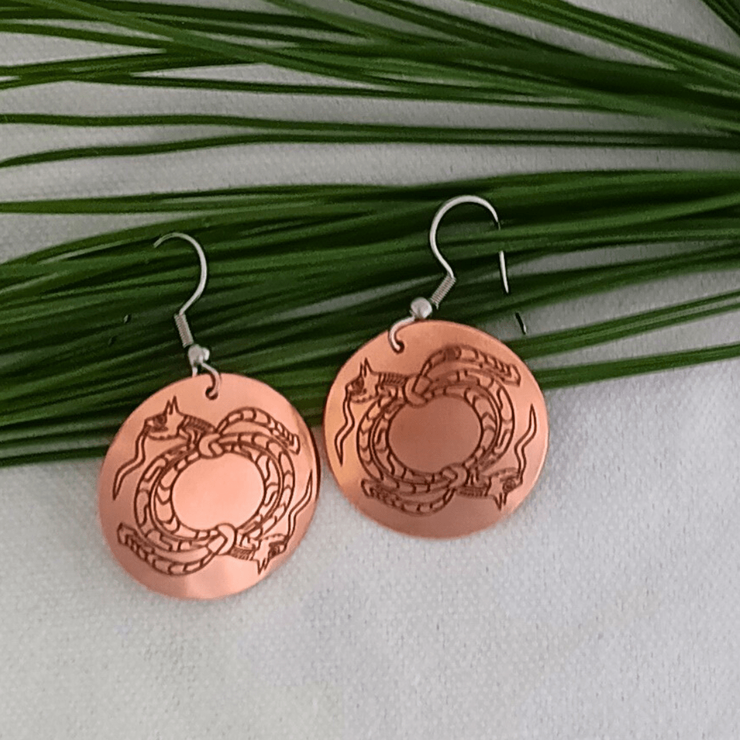 Copper dragon earrings with green foliage