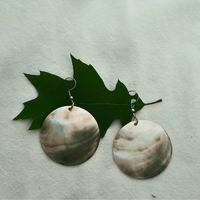 Black lip shell earrings with copper accents on leaf