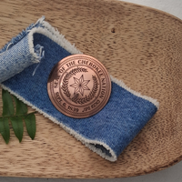Cherokee Nation Seal Brooch in a wooden bowl
