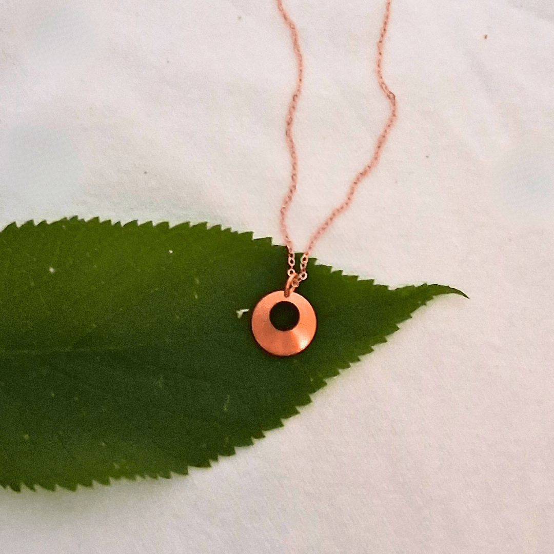 Norah necklace by Cherokee Copper on green leaf