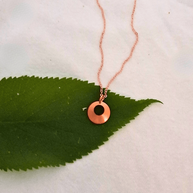 Norah necklace by Cherokee Copper on green leaf