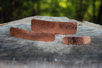Copper jewelry pieces on wood
