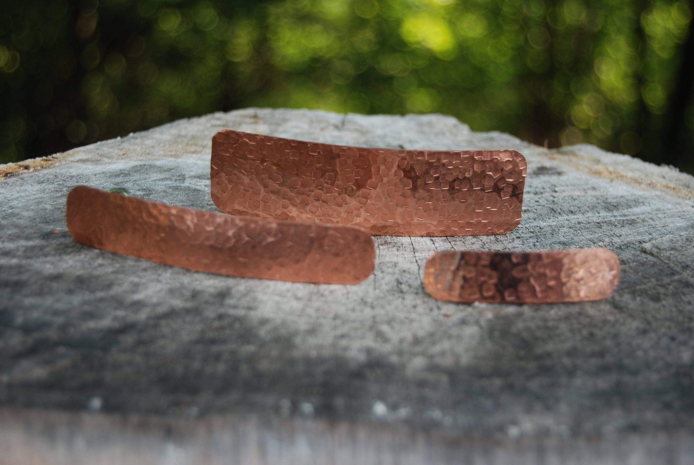 Copper jewelry pieces on wood